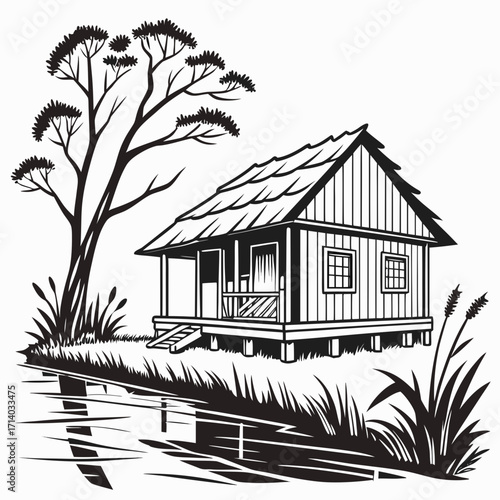 Rustic wooden stilt house with thatched roof beside a calm body of water and a tall tree