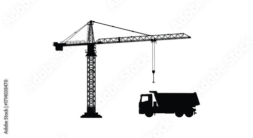 Black silhouette of a construction crane and a dump truck below