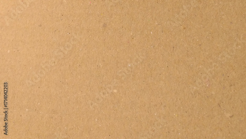 Background of brown kraft paper or cardboard texture. Abstract pattern of beige rough carton, old paper sheet, parchment or papyrus surface.