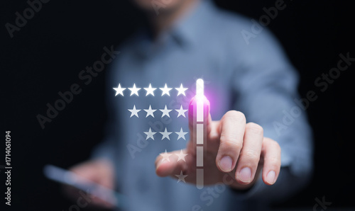 Tableau sur toile Businessman hand pressing five-star rating on virtual screen, concept of customer satisfaction, feedback, quality service, and user experience improvement for digital business success