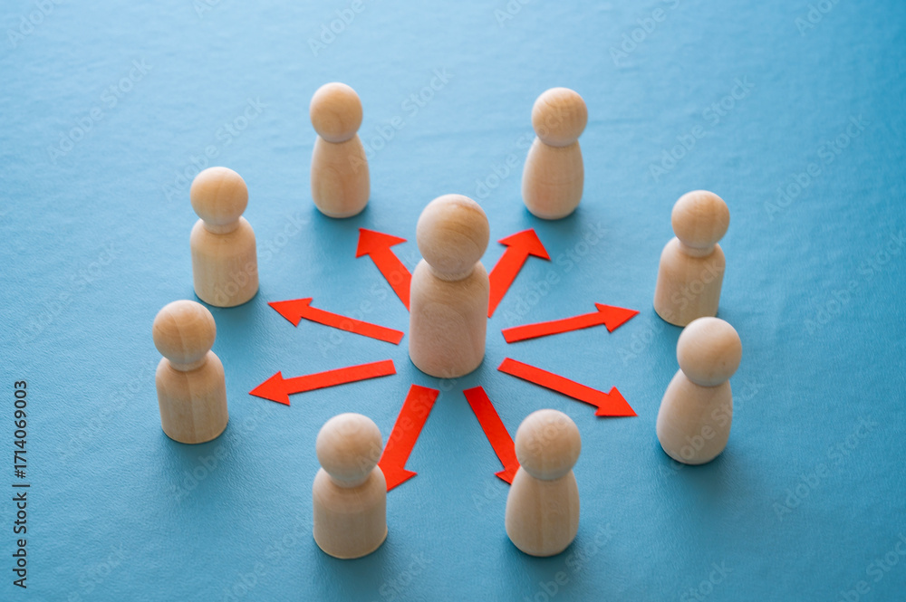 Obraz premium Concepts of communication, leadership, guidance, hierarchy, connection, expressed with a wooden figure and red arrows pointing to other figures.
