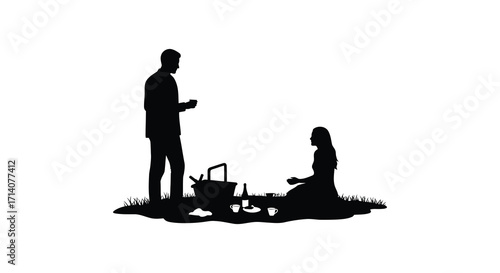 Silhouette of a couple enjoying a romantic picnic outside