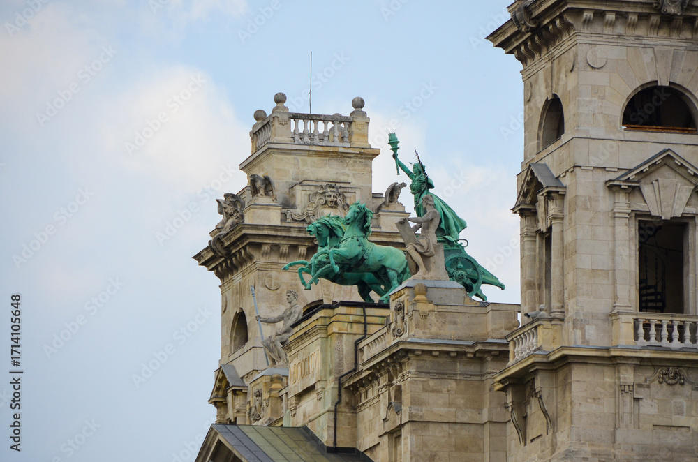 Fototapeta premium Detail view of bronze horseman statue on the rooftop of a historic building in Budapest, Hungary