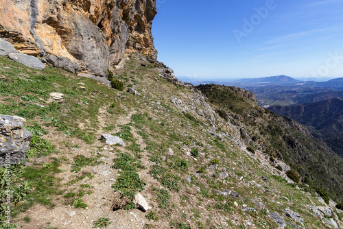 Mountain landscape with an imposing cliff and panoramic views of the Costa del Sol.