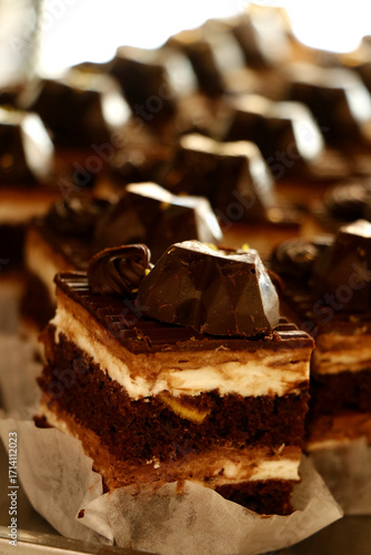 Canvas Print Chocolate layered cake squares with cream filling topped with glossy chocolate decoration
