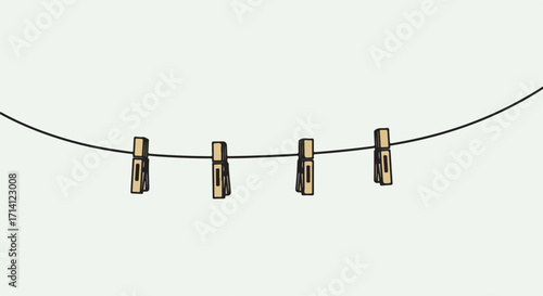 Clothesline with wooden clothespins suspended from line on clean backdrop. Minimal clothesline design featuring classic pins hanging in simple arrangement.
