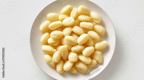 Gnocchi pasta dumplings piled high on a round white plate, simple presentation