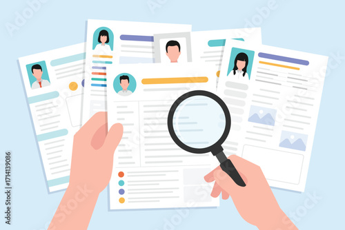 Hand holding magnifying glass for search and finding on a many CV resume paper sheet.