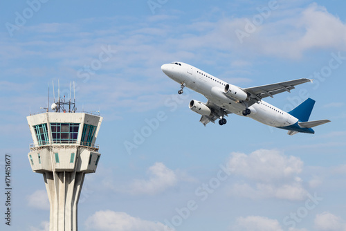 Air control tower and airplane on blue and cloudy sky background. Istanbul Ataturk airport air control tower.  Airline transportation idea concept.
