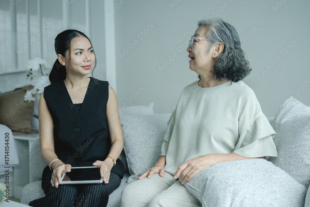 Fototapeta premium Real estate agent consulting elderly customer inside modern home details on digital tablet symbolizing property advice, housing investment or home purchase decisions and supportive customer care.