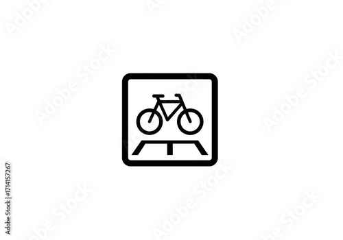 Black icon of bicycle crossing over a road enclosed in square