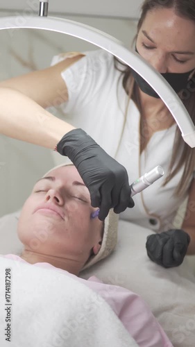 Close-up of facial microlining procedure for a young girl in a beauty salon.