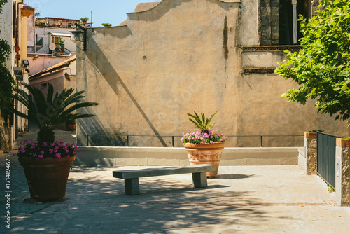 Tableau sur toile Quiet courtyard with stone bench and potted plants in Ravello, Amalfi Coast, Italy