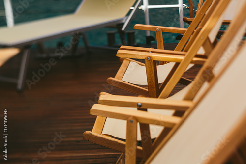 Wooden deck chairs on a terrace with sea view, summer vacation concept, outdoor relaxation, resort leisure, holiday destination, tourism and hospitality background
