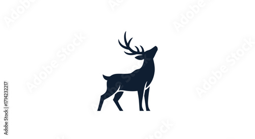 Elegant standing deer silhouette with large antlers looking up.