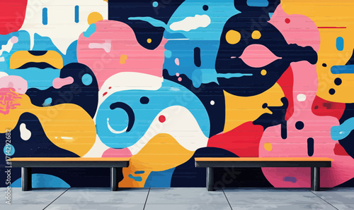 Colorful abstract urban mural street art with fluid shapes and bold contrasting colors on wall with benches in foreground outdoor public space