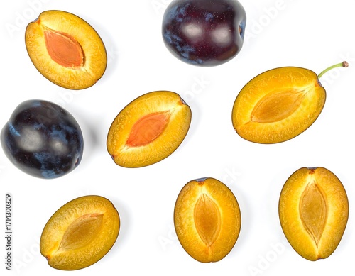 Assorted plum halves on white background