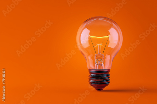 A single clear incandescent light bulb photographed on a vibrant orange background. The glowing filament and glass reflection create a minimalist composition emphasizing shape.