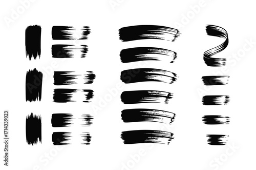 Set of black artistic brush strokes and paint daubs isolated on a white background.