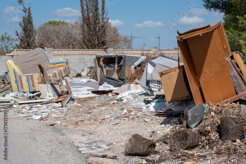 Fotografie Illegal dumping, fly-tipping by the side of the road.