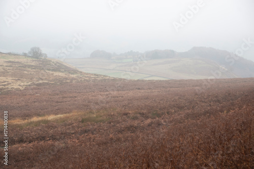 Mist descends and obscures the landscape on a foggy day in the Peak District