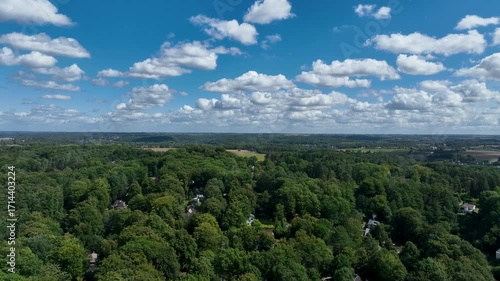 Aerial view of Genappe municipality and city of Wallonia located in the Belgian province of Walloon Brabant. Villas with garden surrounded by forest.