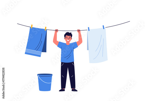 Man hanging laundry on a clothesline with a bucket.