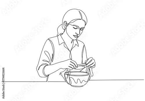 Woman covering a bowl of food with cling film in a kitchen setting  