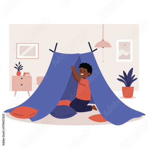 Boy plays in tent in cozy room, with a nightstand, wall art, lamp, and plant