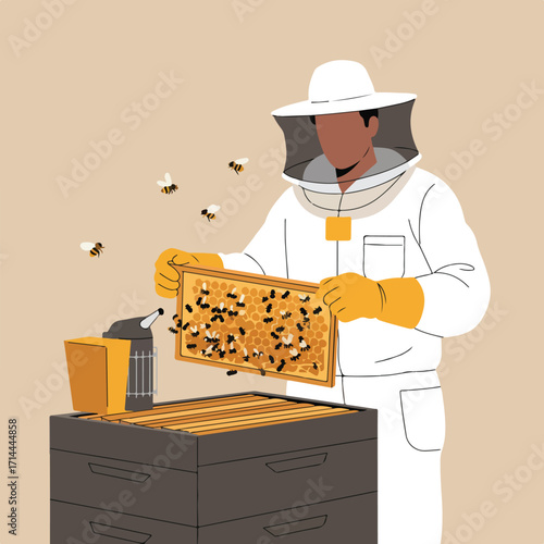 A beekeeper in protective gear holds a honeycomb frame covered in bees near a hive