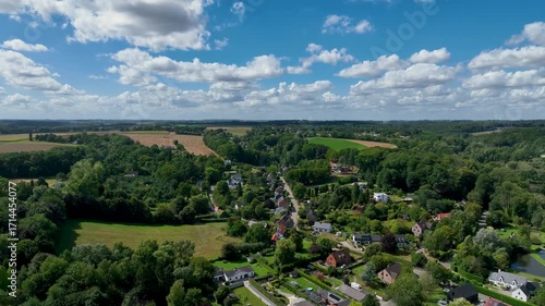 Aerial view of Genappe municipality and city of Wallonia located in the Belgian province of Walloon Brabant. Villas with garden surrounded by forest.