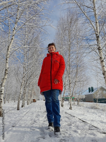 young woman walking in winter park