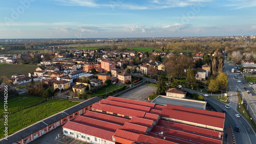 Fototapeta Naklejka Na Ścianę i Meble -  Scenic aerial view of Castelvetro Piacentino nestled near the SS 10 highway in the Piacenza province of Italy revealing picturesque countryside and historic Italian architecture under a clear blue sky