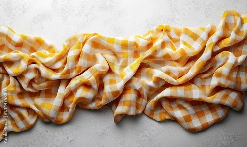 Draped yellow and white checkered cloth on a light surface