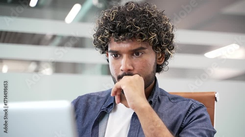 Thoughtful businessman working on laptop in business office. Manager thinking about problem solving sitting at workplace. Entrepreneur is engaged in task or is busy with project on computer. Close up
