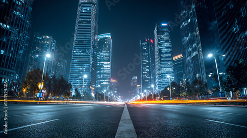 Night view of a modern city street with towering skyscrapers and vibrant long exposure vehicle light trails