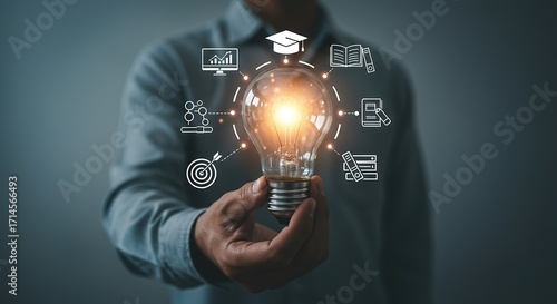 Person holding bright light bulb with digital icons representing innovation and ideas