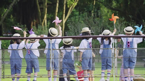 Japanese School Children Waving Pinwheels on Childrens Day Outdoor Event