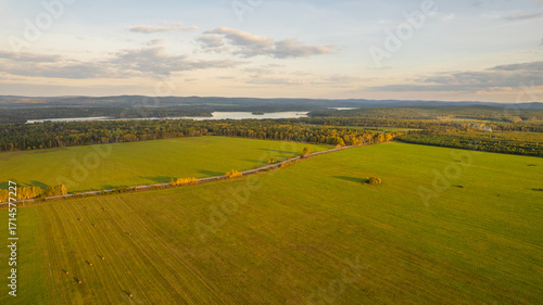 Aerial View of Green Fields, Forest and Lake at Sunset