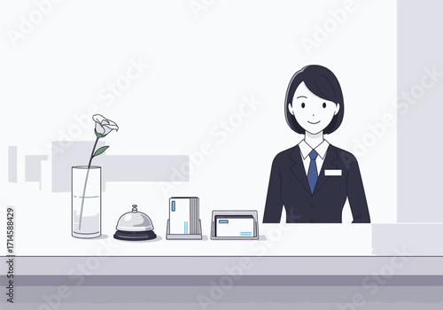 Friendly hotel receptionist standing behind a counter with service bell and flower