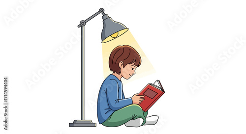 A young boy sits on the floor, engrossed in reading a book under the warm glow of a desk lamp.