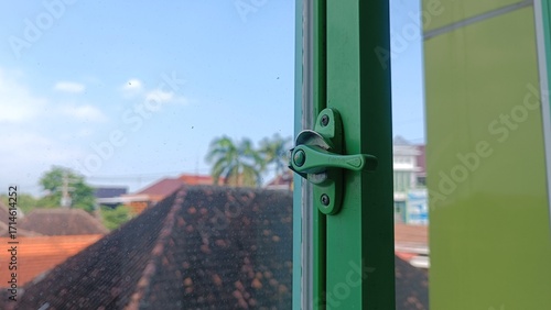 Green window frame with latch detail