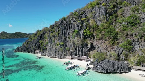 Coron, Palawa, Philippines, in South East Asia, with White Sand Beach, Turquoise Water, filmed on an Island island hopping boat tour with Limestone Cliffs in the background