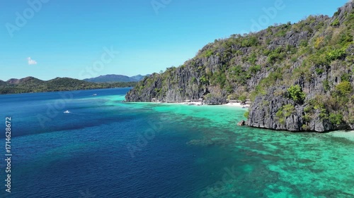 Coron, Palawa, Philippines, in South East Asia, with White Sand Beach, Turquoise Water, filmed on an Island island hopping boat tour with Limestone Cliffs in the background