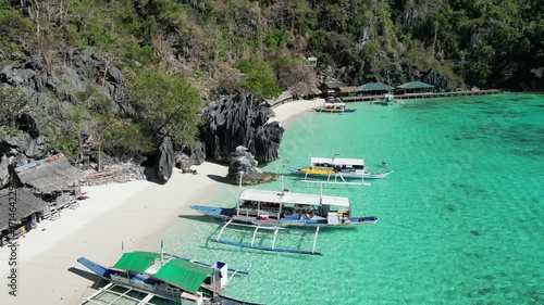 Coron, Palawa, Philippines, in South East Asia, with White Sand Beach, Turquoise Water, filmed on an Island island hopping boat tour with Limestone Cliffs in the background