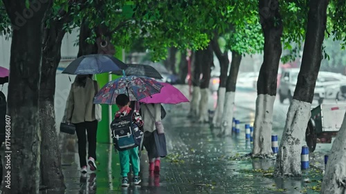 Students Going Home from Elementary School on Rainy Day with Umbrellas and Backpacks