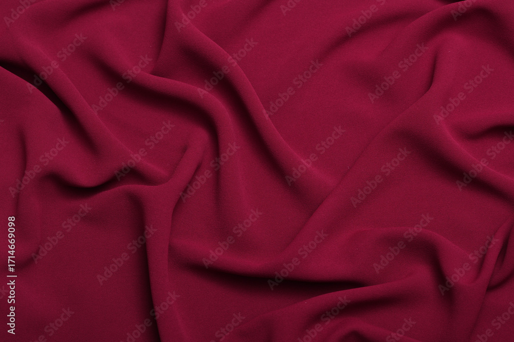 Obraz premium Soft lightweight flowy georgette fabric in maroon red, elegantly draped with natural folds. Perfect for fashion design, textiles, sewing, dressmaking, and delicate feminine style concepts.