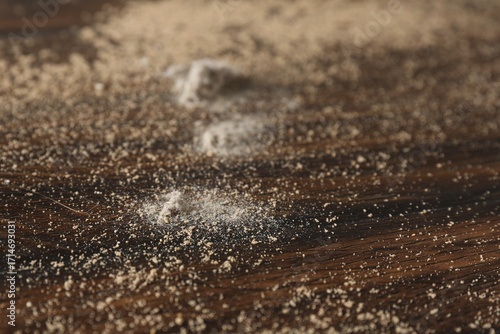 Wooden table covered with dust, closeup view