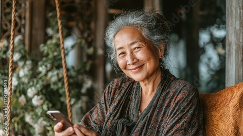 Smiling Older Woman Relaxing While Using Smartphone in Cozy Setting