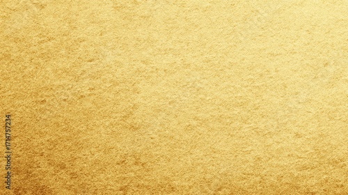 The smooth gold surface shines, suggesting a luxurious and elegant feel, with slight texture adding dimension to the golden backdrop.